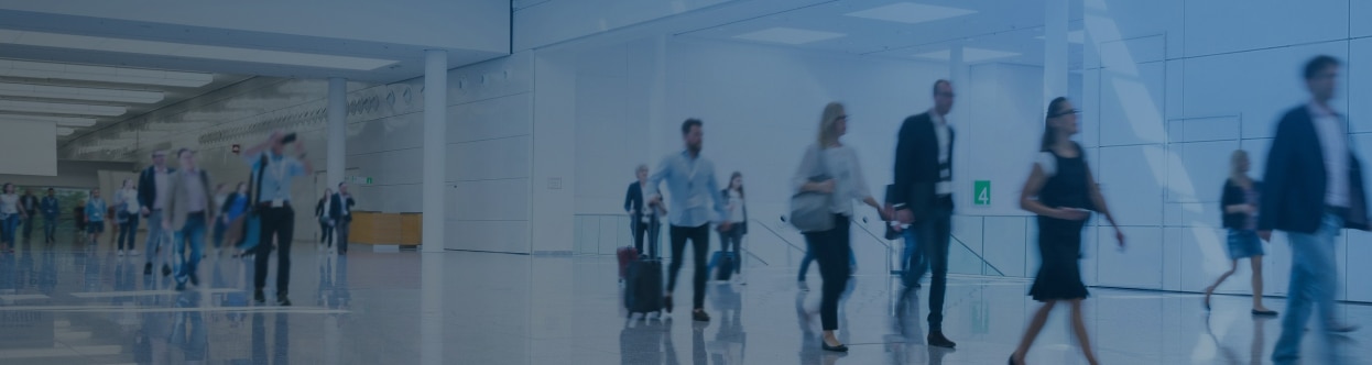 People walking in an airport terminal, overlaid with a blue gradient