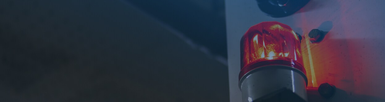 Close-up of a siren on an ambulance, overlaid with a blue gradient